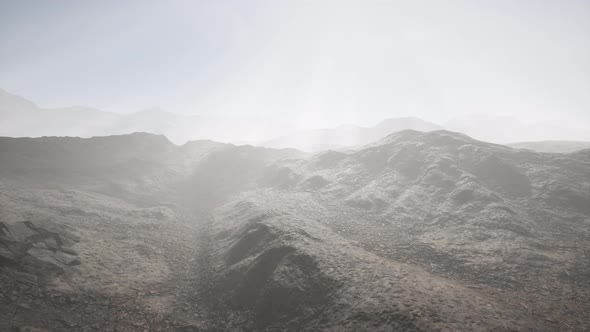 Sun Rays Over Mountains in a Valley