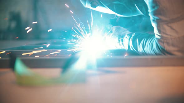 Welding Process in the Workshop - Protective Glasses on the Foreground Unfocused