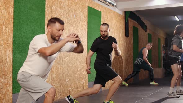 Sporty Beautiful Happy Young Men Warming Up Stretching Before Morning Running Routine High Lunges