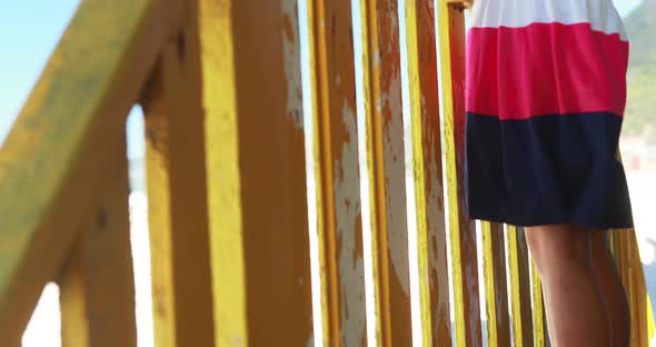 Girl photographing with camera from colorful beach hut