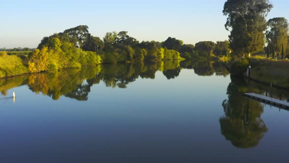 Low flying aerial over calm river waters in Sacramento San Joaquin River Delta