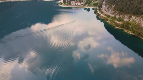 Drone goes down following a little boat on Ledro lake, Trentino, Val di Ledro in North Italy. Aerial