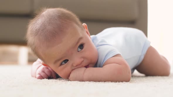 Sweet Little Asian Baby Boy Sucking Fingers