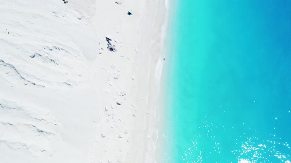 Drone view of scenic beach with white sand and turquoise sea, Greek islands.