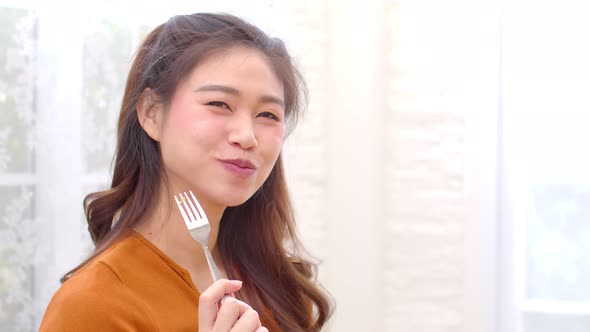 Healthy Young Asian woman eat mixture of vegetables Fresh Salad at home