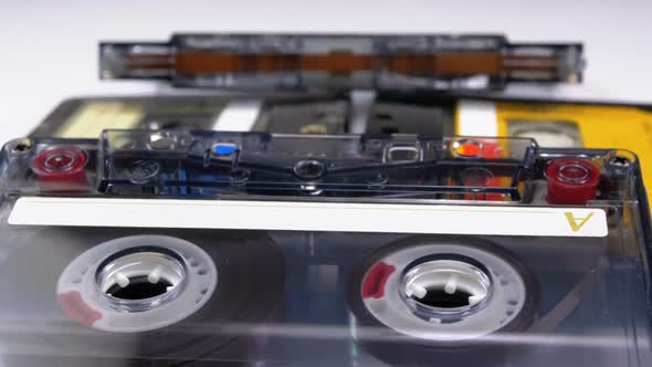 Four Audio Cassettes Rotate on White Background
