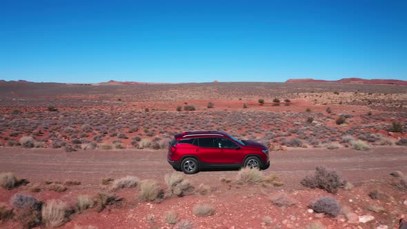 Red car in the desert on a day