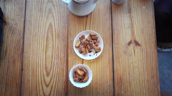 Hands of Two People Taking Snacks Kept in a Bowl in Manali , Himachal Pradesh , India During Tea