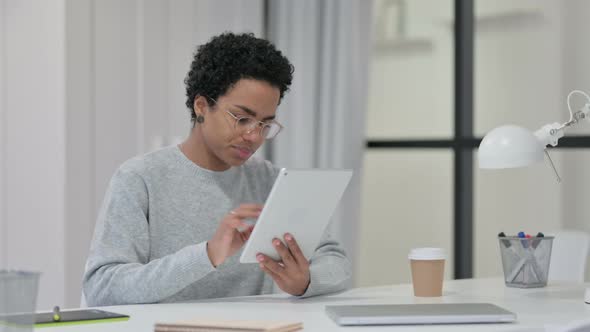 Young African Woman Using Tablet at Work 