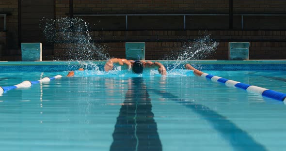 Male swimmer swimming inside pool 4k