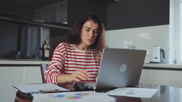 Freelancer Working on Laptop at Home