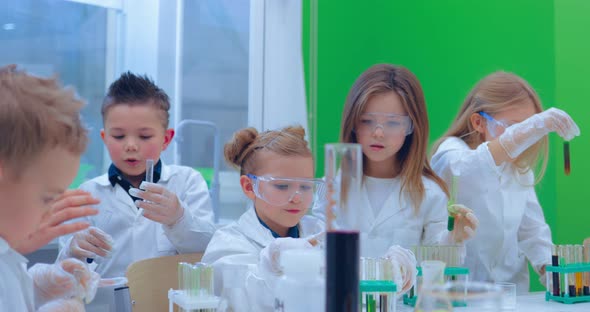 Pupils and Teacher Watching Experiment in Science Class