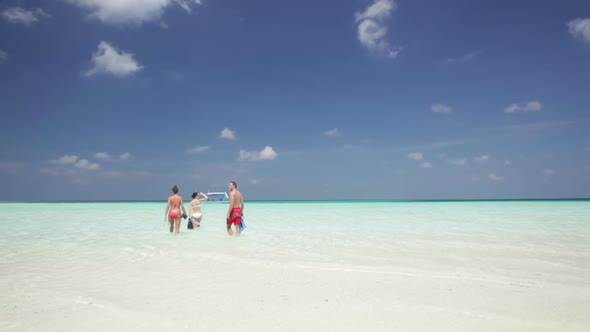 People Walking in Tropical Lagoon