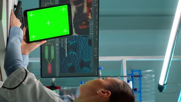 Vertical Video Microbiologist Working on Notepad with Green Chroma Key Display