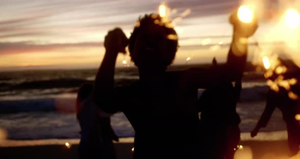 Friends playing with sparklers on the beach 4k