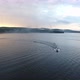 Motor boat floats across the lake at sunset aerial view - VideoHive Item for Sale