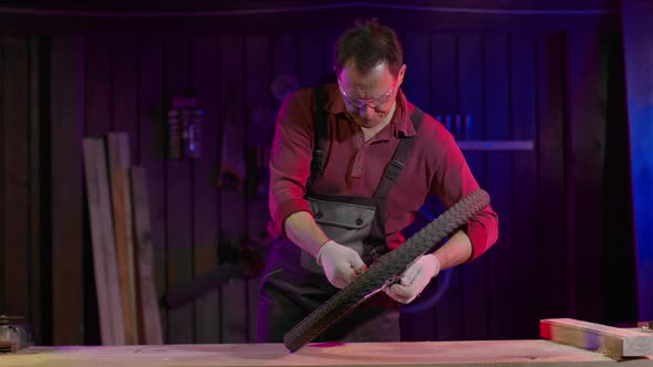 Man Checks for Defects and Breakdowns in the Bicycle Wheel in the Garage