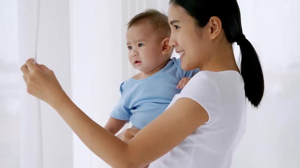 Close up of young mother is holding her little baby.