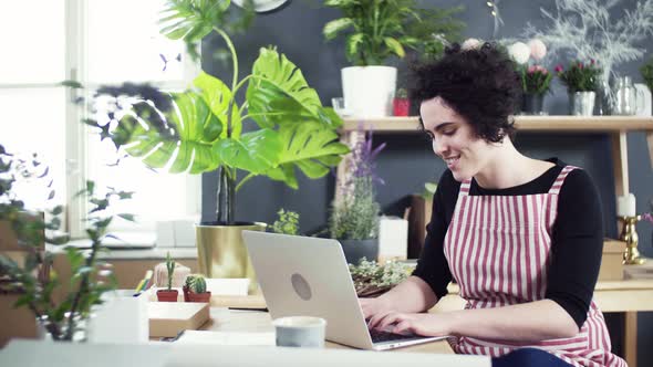 Young florist checking incoming mail orders