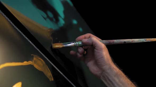 Slow motion: man's hand is painting with brush during the night. Graffiti and street art concept in
