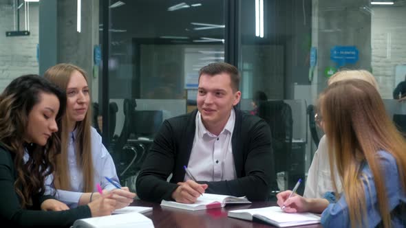 Business partners in the meeting room discuss the project