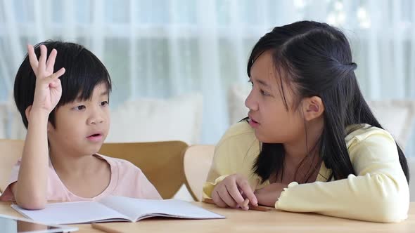 Asian Children Doing Homework Together