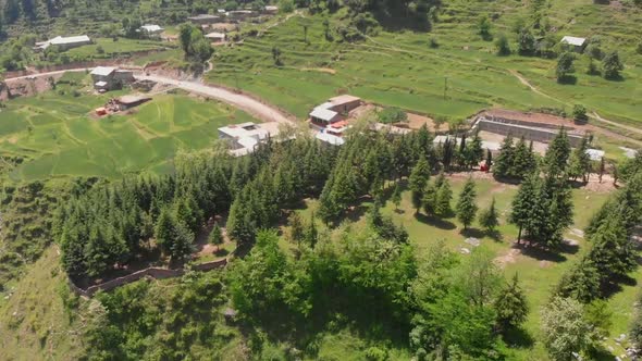 Aerial Over Green Landscape With Buildings At Gabin Jabba In Pakistan. Dolly Forward