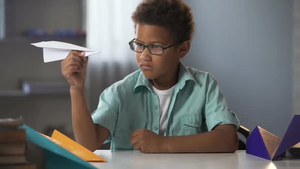 Afro-American Boy Learning to Make Paper Airplanes, Future Engineer Designer