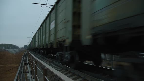 Freight Train Close To the Camera on the Railway Bridge on the Right