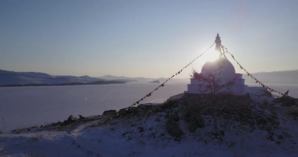 Sun is Shining Through The Buddhist Stupa. Tracking Left