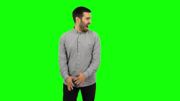 Brunette Guy Is Very Angry and Screaming. Green Screen