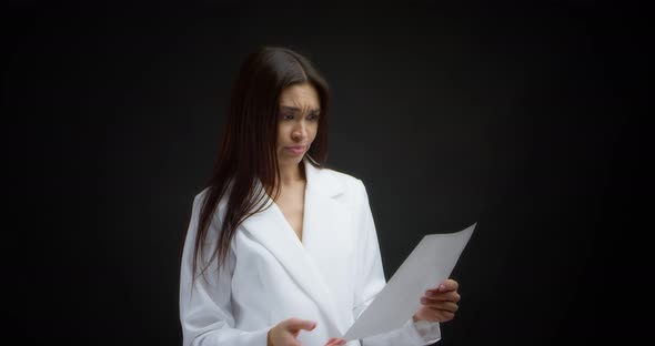 Angry Businesswoman Crumples White Sheets of Paper and Throws Them on the Floor