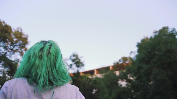 Portrait of Young Stylish Hipster Woman with Green Looking at Sky Slow Motion Tracking Shot