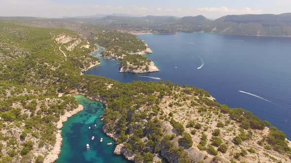 Aerial travel drone view of clear green water, cliffs of Cassis, Mediterranean Sea, Southern France.