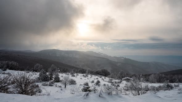 Time lapse with fast-moving mists and snowfall over mountain slopes