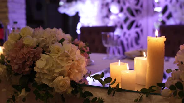 candles burn on the wedding table in the restaurant