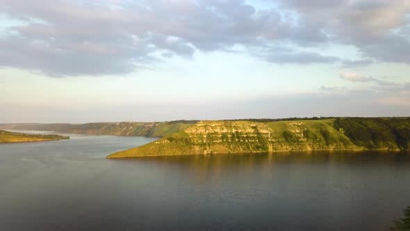 Aerial view of wide Dnister river and distant rocky hills in Bakota area, part of the National park 