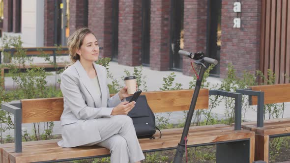 Businesswoman Drinking Coffee Outdoors