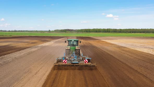 The Tractor Plows the Field Prepares for Crops