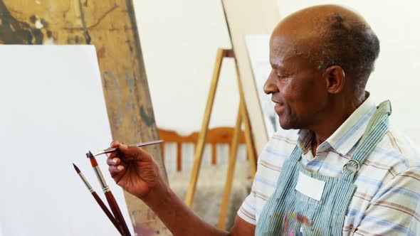 Confident artist holding paintbrush