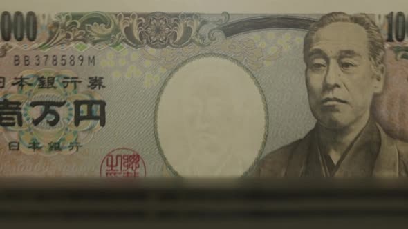 10000 Japanese Yen banknotes in cash machine.