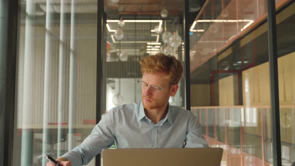 Portrait of Successful Confident Young Businessman Make Notes in Office