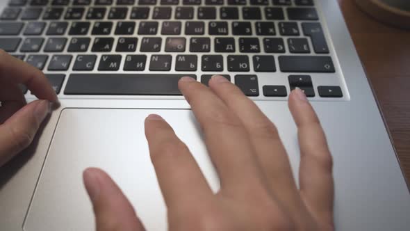 Closeup of Young Caucasian Woman's Hand on Laptop Work with Touchpad