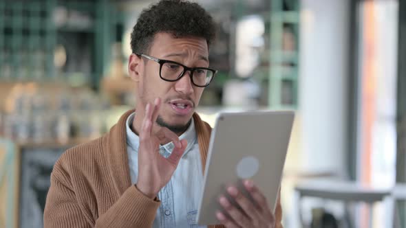 Video Chat Tablet By Young African Man