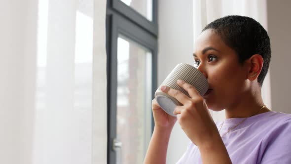 African Woman Drinking Tea or Coffee at Home