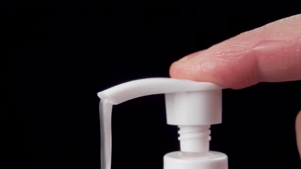 Close-up of a male finger squeezing out hand sanitizer