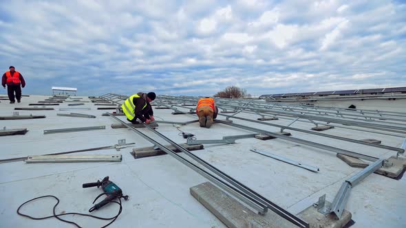 Engineers installing metal basis for future solar panels