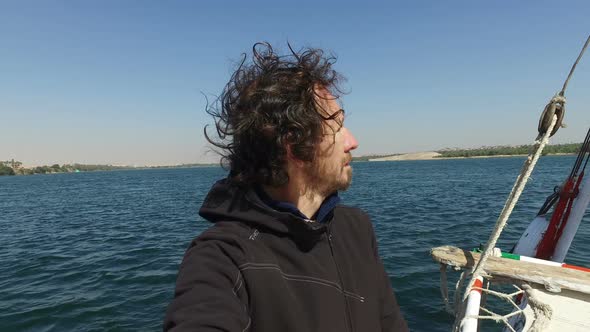 Male tourist standing on bow of felucca