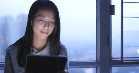 Woman use of tablet computer at night 