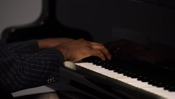 Side View of Male Hands Playing the Grand Piano